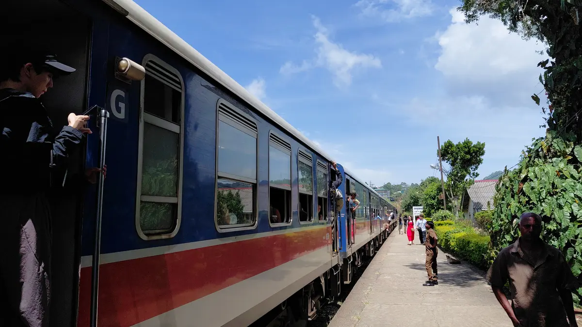 Train stopped beside a railway platform.